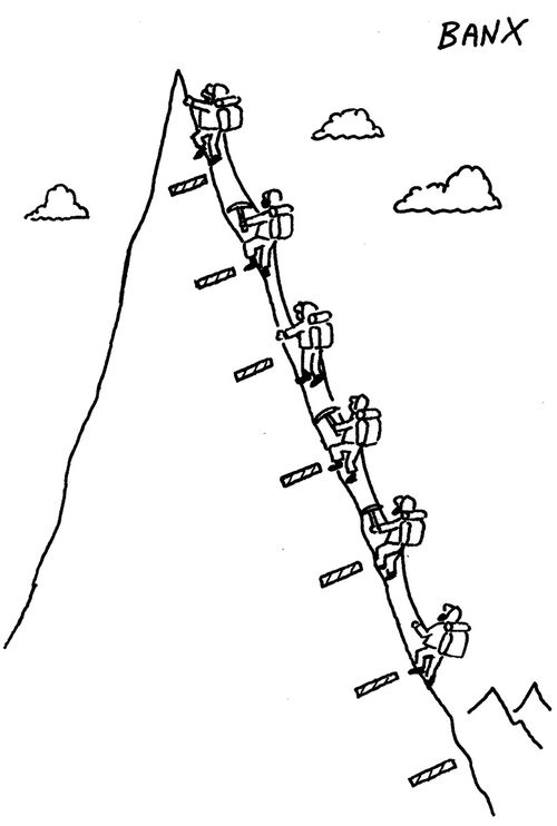 Six hikers climb to a narrow peak.
