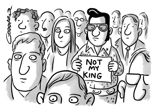 Elvis fan holding a sign reading 'NOT MY KING'.