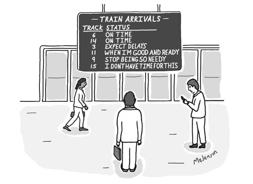  A man is stood in at a train station watching a train arrivals board.