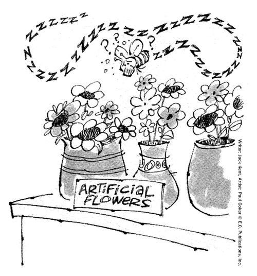 A confused bee flies around artificial flowers.