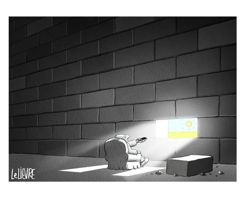 A man points a remote at a hole in a grey wall