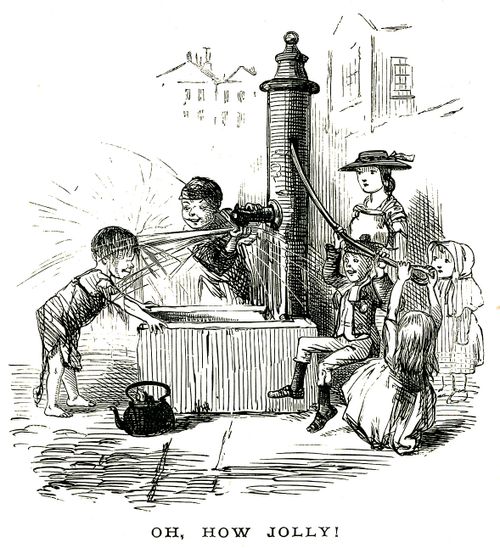 Children playing around a water pump