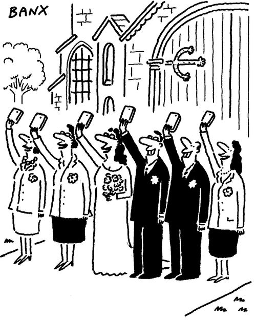 The wedding party take selfies at a wedding