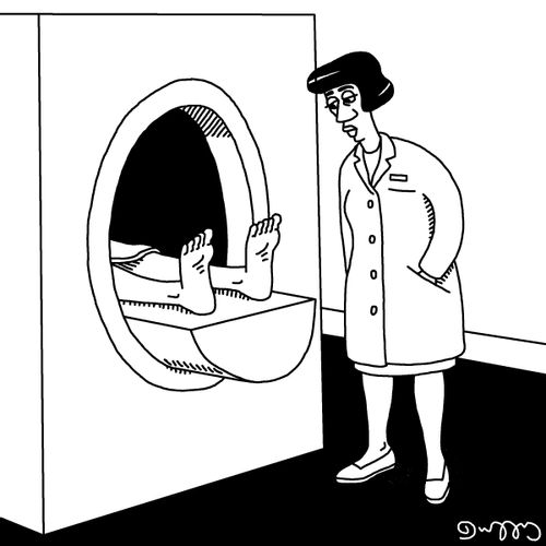 A woman is staring at someone's feet when they are in an MRI machine.